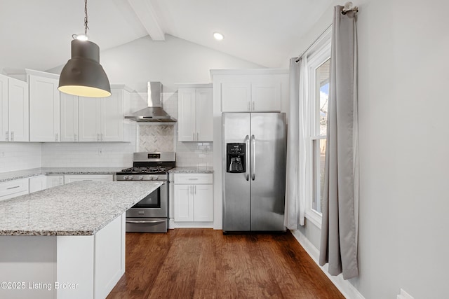 kitchen featuring vaulted ceiling with beams, decorative light fixtures, wall chimney range hood, stainless steel appliances, and white cabinets