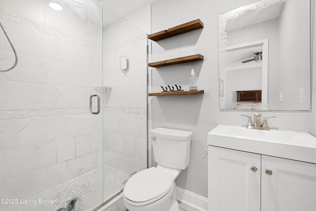 bathroom with vanity, an enclosed shower, ceiling fan, and toilet