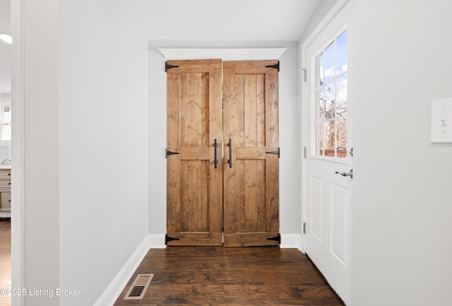 doorway featuring dark wood-type flooring