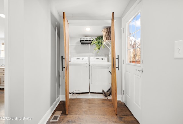 laundry area with light wood-type flooring and washer and clothes dryer