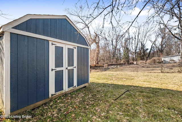 view of outbuilding with a yard