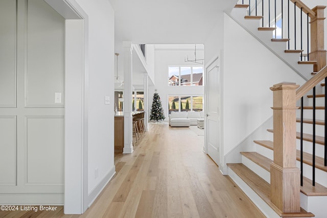 interior space with light hardwood / wood-style floors and an inviting chandelier