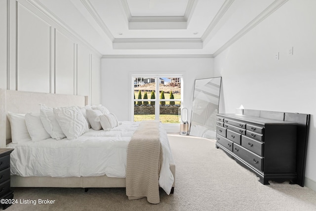 carpeted bedroom with a raised ceiling and ornamental molding