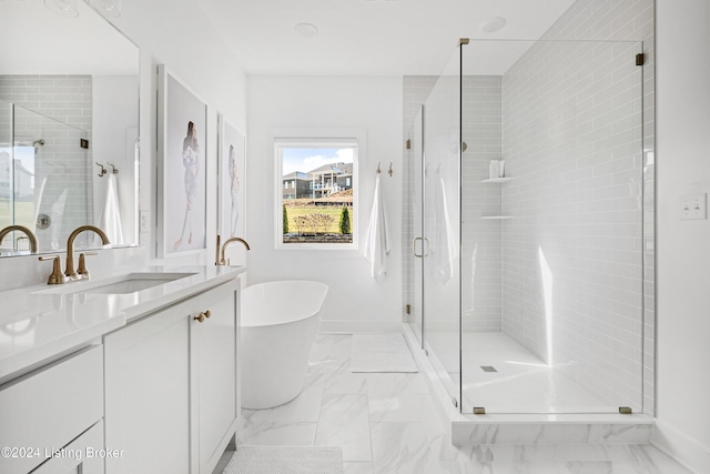 bathroom with vanity and independent shower and bath