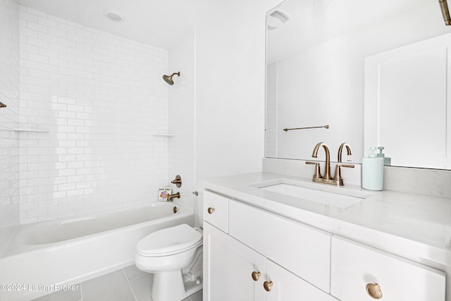 full bathroom featuring tile patterned flooring, vanity, toilet, and tiled shower / bath