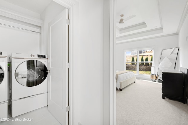 washroom featuring light carpet, washing machine and dryer, ceiling fan, and ornamental molding