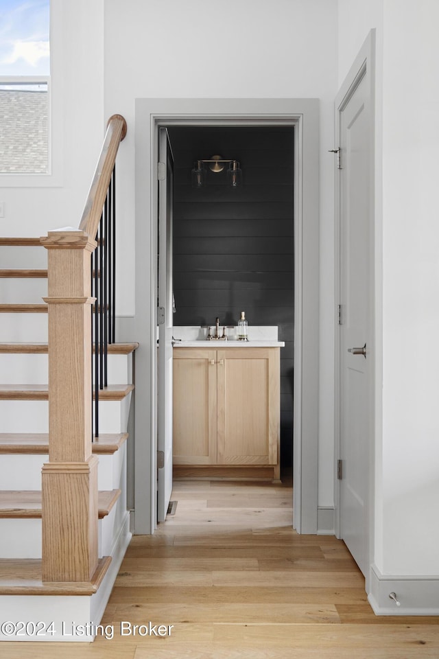 hall featuring light hardwood / wood-style flooring and sink