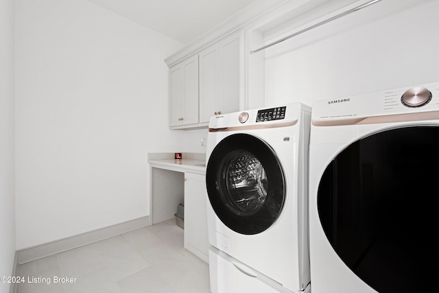 laundry room featuring cabinets and washing machine and clothes dryer