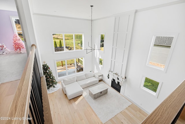 living room with a notable chandelier and light wood-type flooring