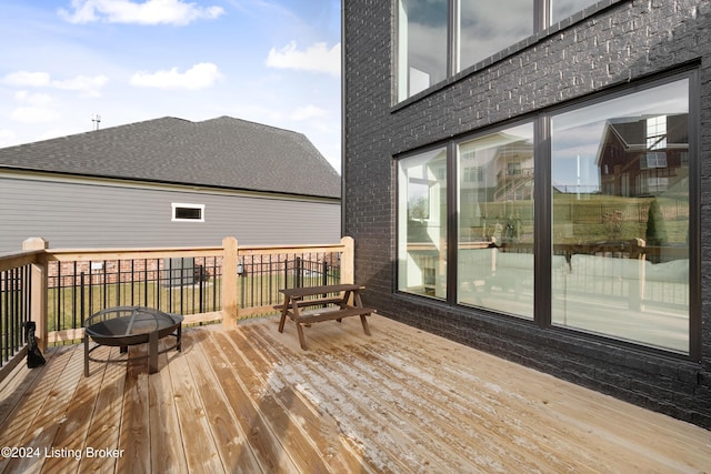 wooden terrace with a fire pit