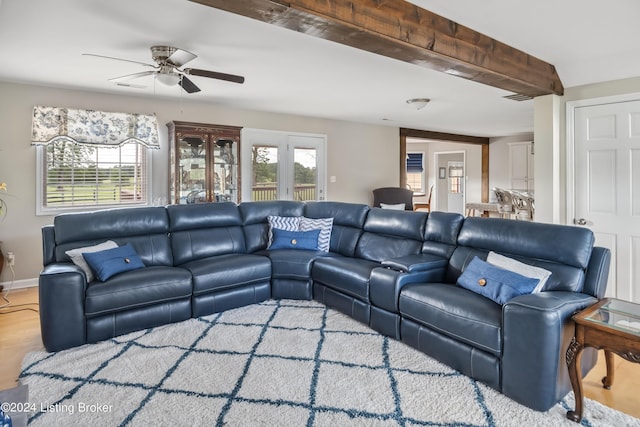 living room with hardwood / wood-style floors, ceiling fan, and beam ceiling