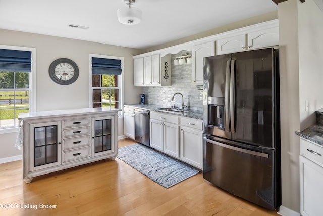 kitchen featuring dishwasher, white cabinets, and refrigerator with ice dispenser