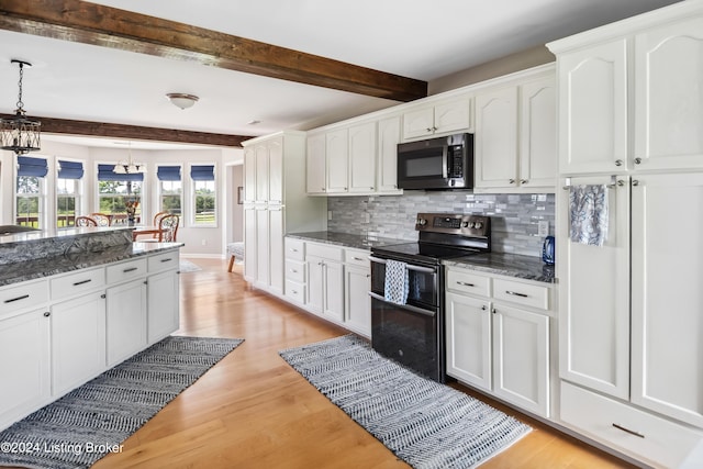 kitchen featuring decorative light fixtures, beam ceiling, white cabinetry, and appliances with stainless steel finishes