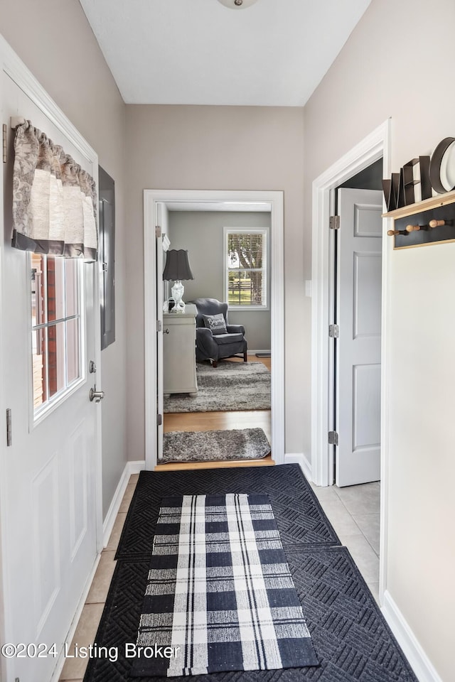 corridor with light tile patterned flooring