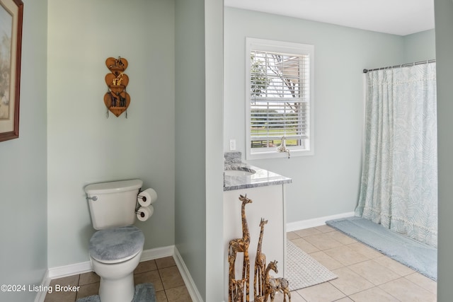 bathroom with tile patterned floors, a shower with curtain, vanity, and toilet