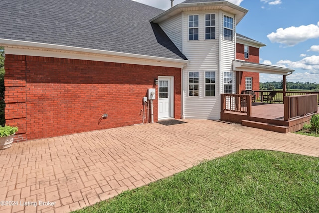 back of property with a patio and a wooden deck