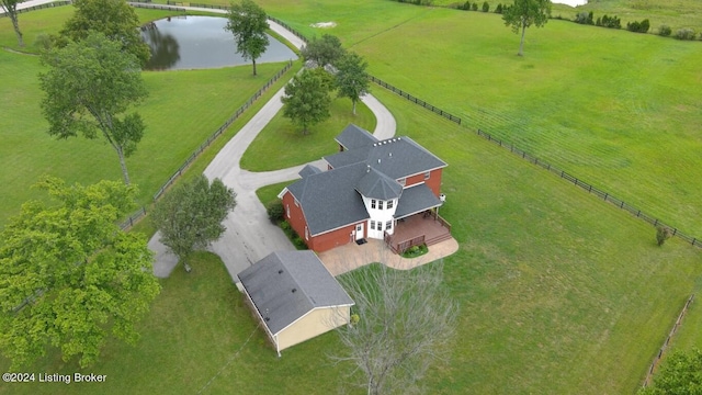 birds eye view of property with a water view and a rural view