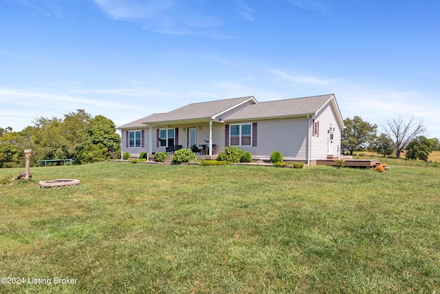 ranch-style home with covered porch and a front lawn