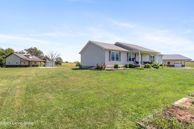 ranch-style house with a front yard, a garage, and a porch