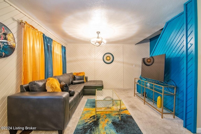 carpeted living room with a textured ceiling and an inviting chandelier