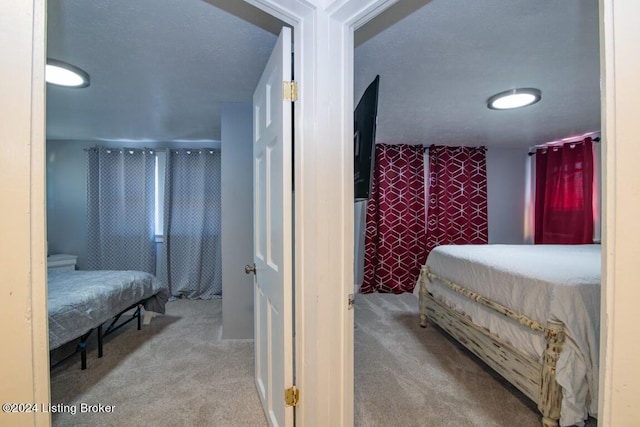 carpeted bedroom featuring a textured ceiling