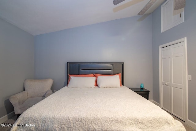 carpeted bedroom featuring ceiling fan, lofted ceiling, and a closet