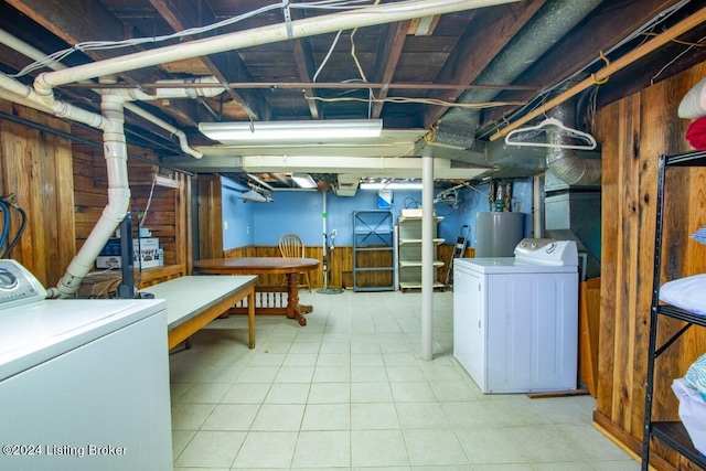 basement featuring wood walls and water heater