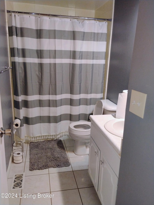 bathroom featuring toilet, vanity, and tile patterned floors