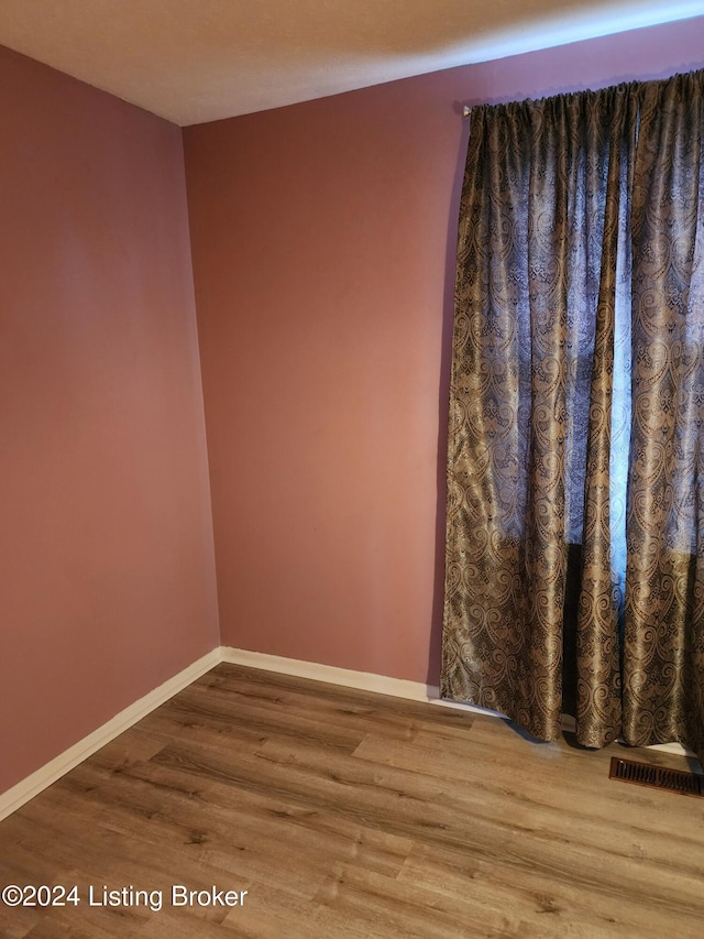 spare room with hardwood / wood-style floors