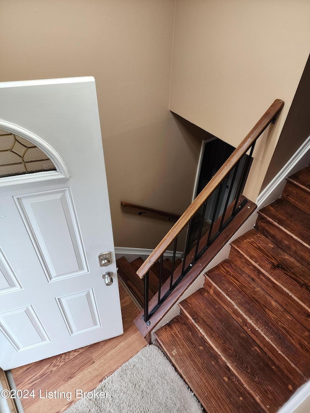 stairs with hardwood / wood-style floors