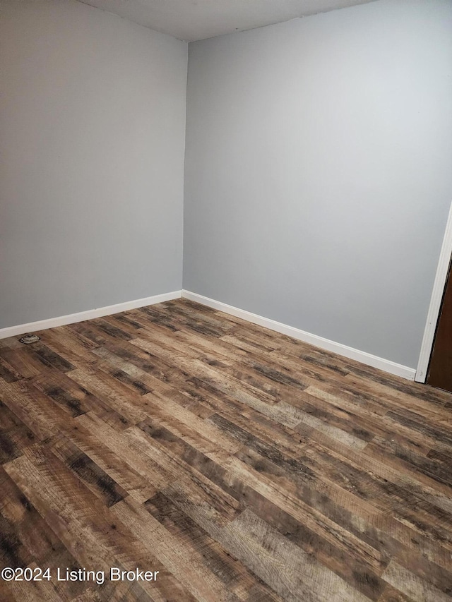 unfurnished room featuring dark hardwood / wood-style flooring