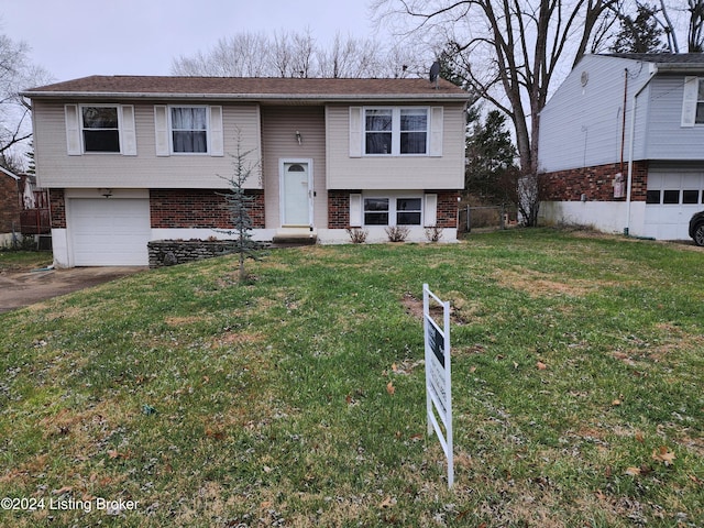 split foyer home featuring a front yard and a garage