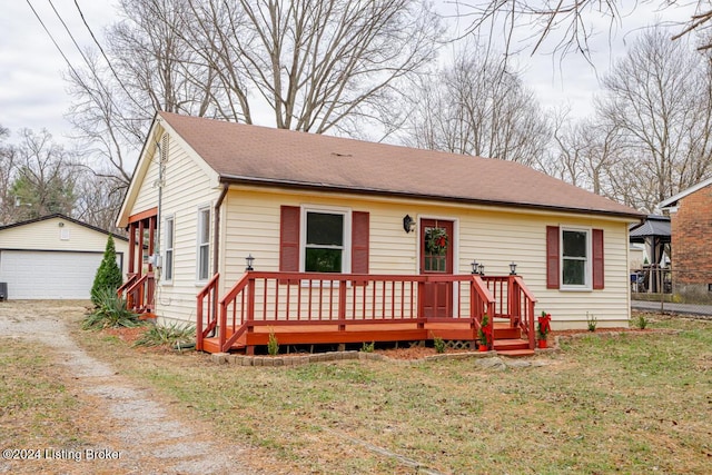 view of front facade featuring a garage, an outdoor structure, a deck, and a front lawn