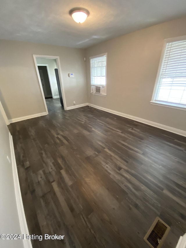 empty room featuring dark wood-type flooring