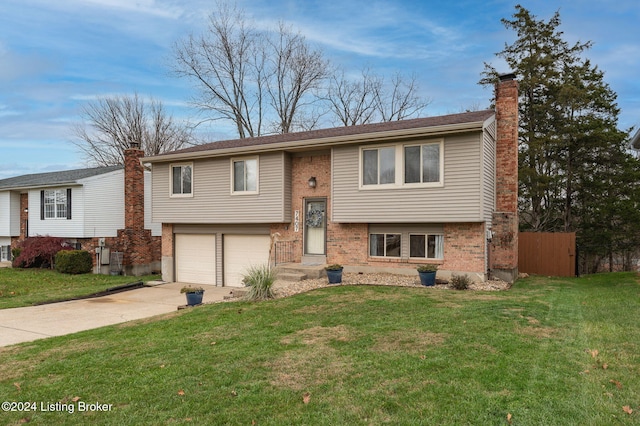 raised ranch featuring a front yard and a garage