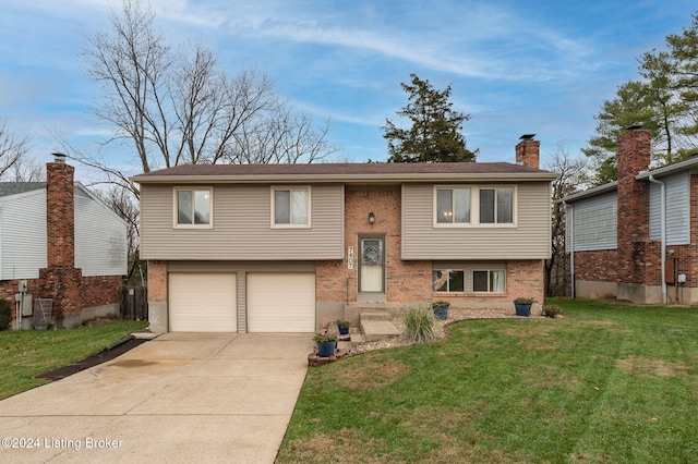 bi-level home featuring a garage and a front lawn