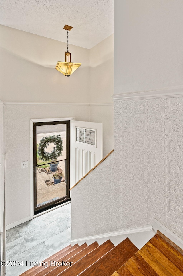 staircase with a textured ceiling