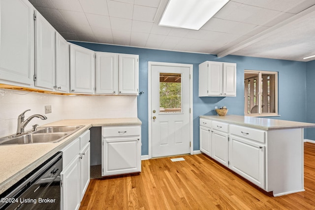 kitchen featuring white cabinetry, sink, dishwasher, and light wood-type flooring