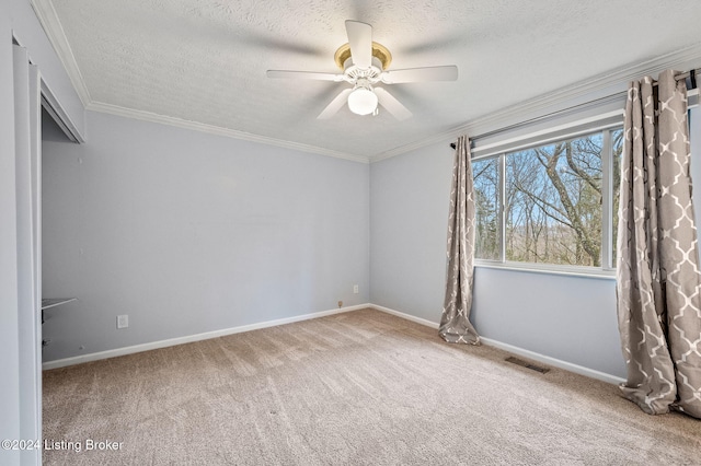 unfurnished bedroom featuring carpet flooring, ceiling fan, ornamental molding, and a textured ceiling