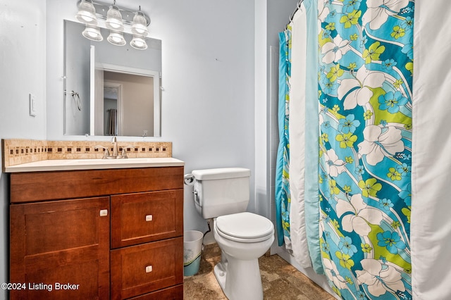 bathroom with tile patterned floors, vanity, toilet, and curtained shower