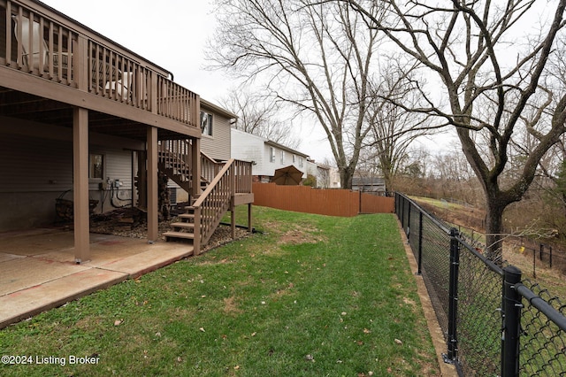 view of yard featuring a patio area and a wooden deck