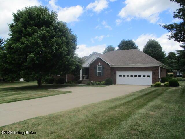 view of front of property with a front lawn and a garage