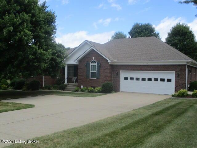 view of front of house featuring a garage and a front lawn