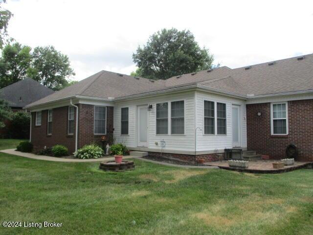 back of property featuring a lawn