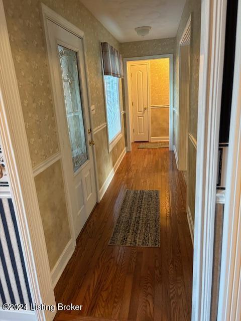 hallway with hardwood / wood-style floors