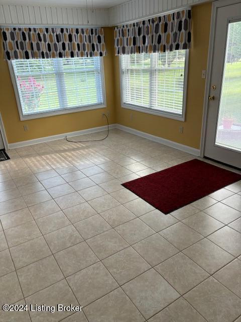 unfurnished dining area featuring light tile patterned floors and a wealth of natural light