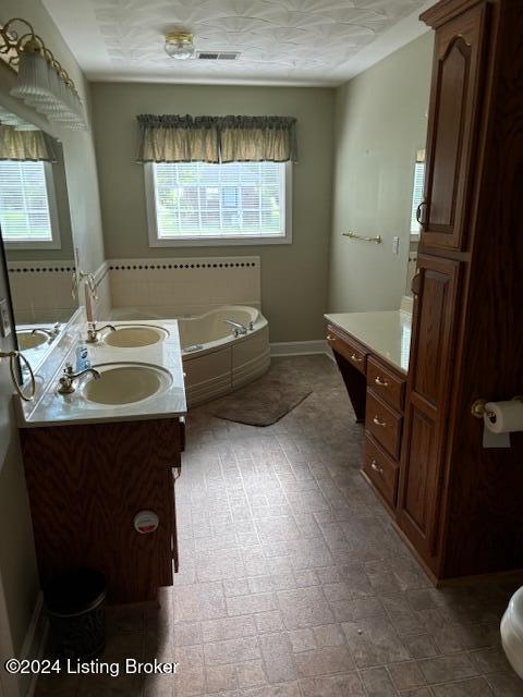 bathroom featuring a washtub and vanity