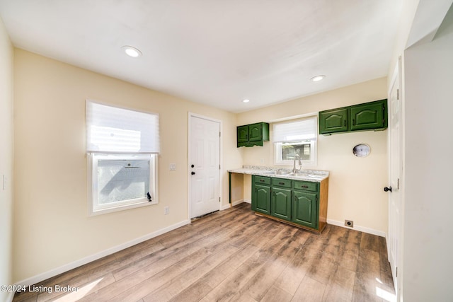 kitchen featuring green cabinetry, sink, a wealth of natural light, and light hardwood / wood-style flooring