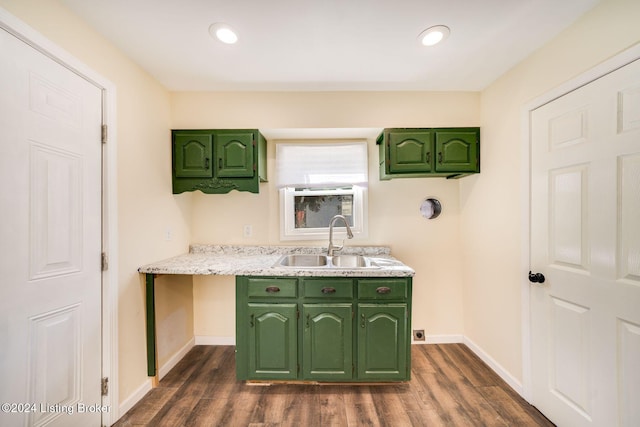 kitchen featuring green cabinets, sink, and dark wood-type flooring