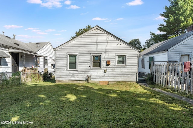 back of property featuring a yard